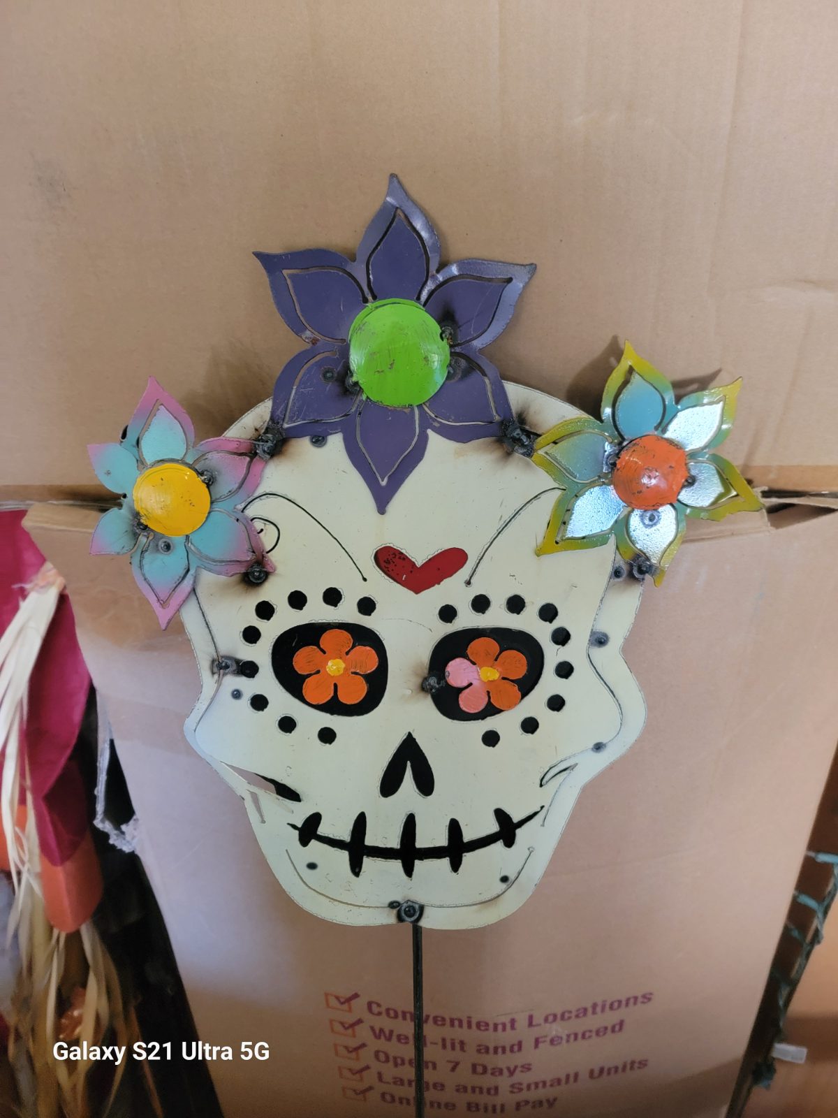 A colorful sugar skull brings festive cheer to the garden.